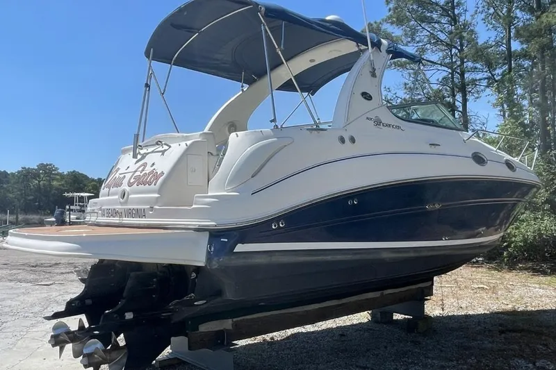 Slide: The Image of 2008 Sea Ray Sundancer 280 boat on dry dock, featuring sleek design and blue hull. - 2