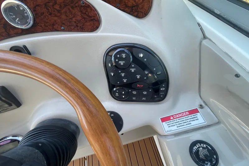 Slide: The Image of Control panel of a 2008 Sea Ray Sundancer 280 boat with wooden steering wheel. - 20