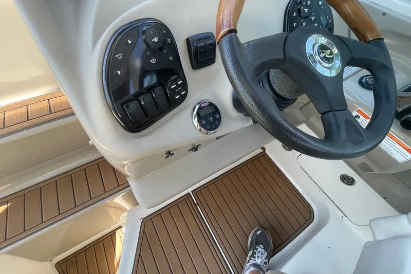 Slide: The Image of Steering wheel and controls of a 2008 Sea Ray Sundancer 280 boat. - 21