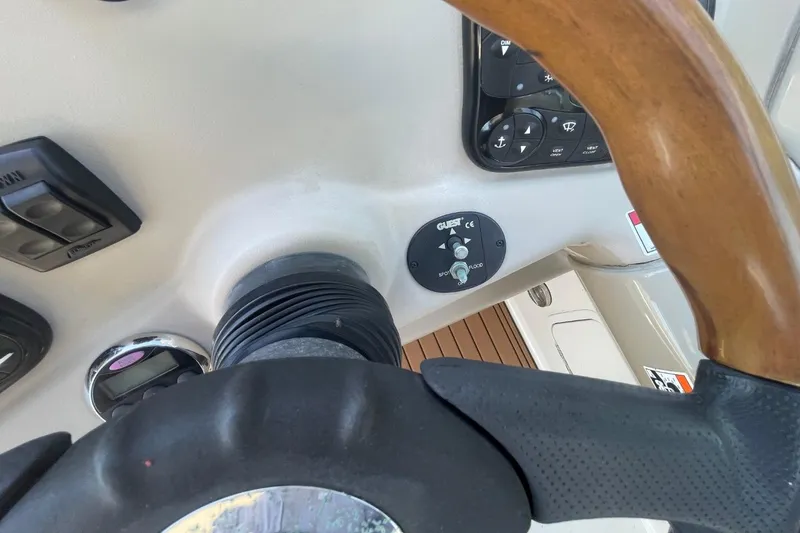 Slide: The Image of Steering wheel and controls of a 2008 Sea Ray Sundancer 280 boat cockpit. - 22