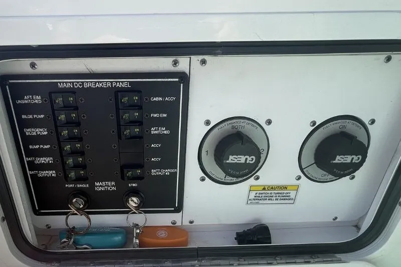 Slide: The Image of Main DC breaker panel on 2008 Sea Ray Sundancer 280 boat, featuring ignition keys and switches. - 26