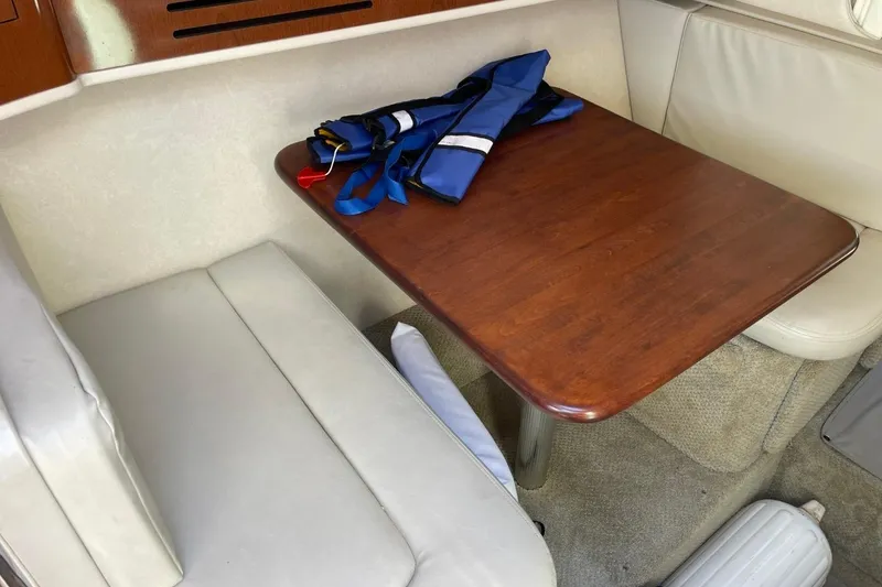 Slide: The Image of Interior of 2008 Sea Ray Sundancer 280 with table, seating, and life jacket. - 34