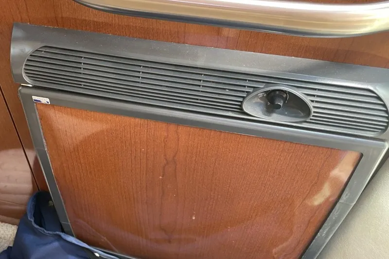 Slide: The Image of Wood-paneled refrigerator in 2008 Sea Ray Sundancer 280 boat interior. - 36