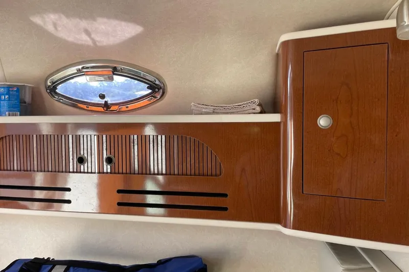 Slide: The Image of Interior of 2008 Sea Ray Sundancer 280 with wooden cabinetry and porthole window. - 39