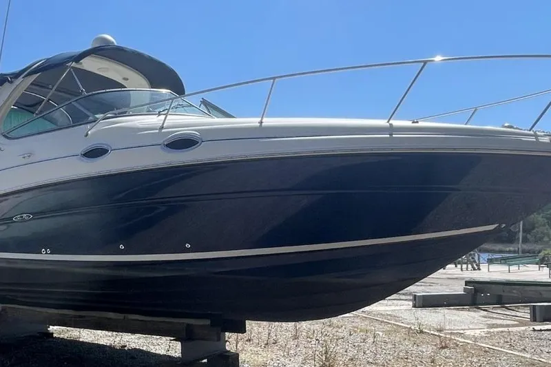Slide: The Image of 2008 Sea Ray Sundancer 280 boat on dry dock under clear blue sky. - 4