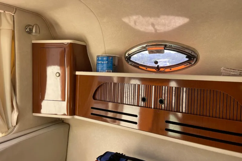 Slide: The Image of Interior of 2008 Sea Ray Sundancer 280 with wooden cabinetry and porthole window. - 40