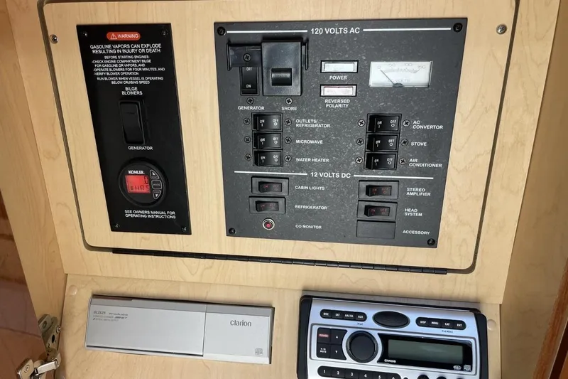 Slide: The Image of Control panel of a 2008 Sea Ray Sundancer 280 boat, featuring electrical switches and stereo system. - 45
