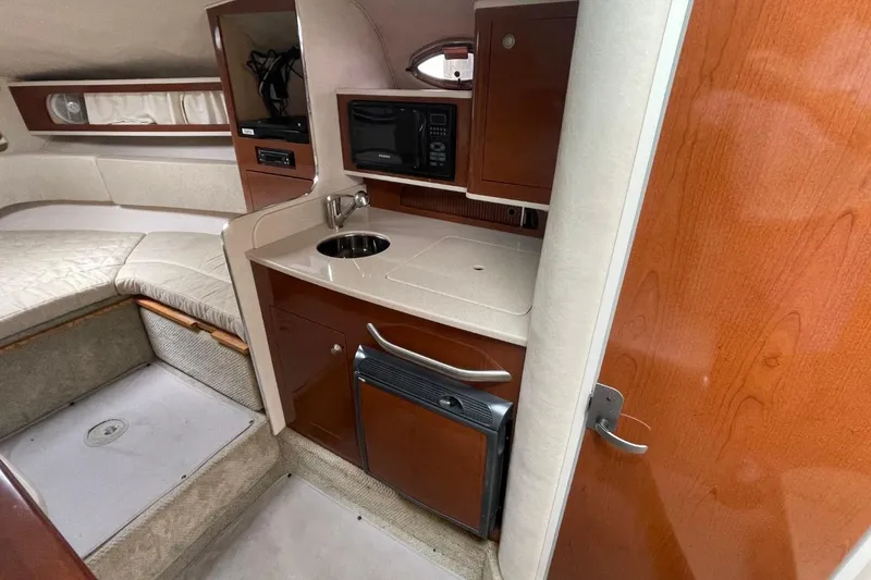 Slide: The Image of 2008 Sea Ray Sundancer 280 cabin interior with kitchenette and seating area. - 49