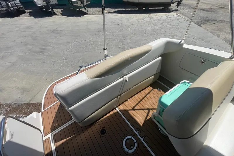 Slide: The Image of 2008 Sea Ray Sundancer 280 docked, featuring blue canopy and wooden deck. - 7