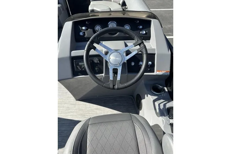 Slide: The Image of 2020 Bennington 21 SSBXP boat dashboard with steering wheel and gauges. - 13