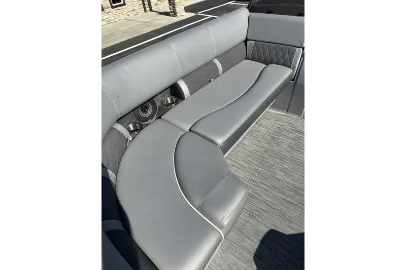 Slide: The Image of 2020 Bennington 21 SSBXP boat interior with gray cushioned seating and cup holders. - 15