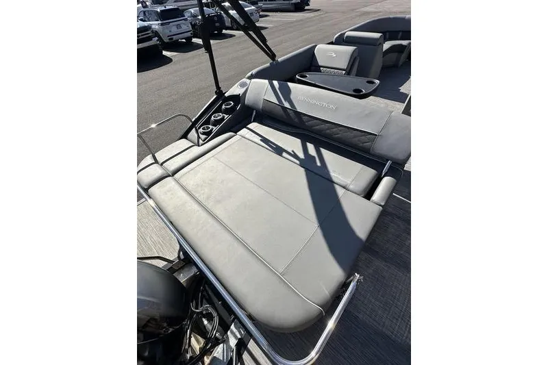 Slide: The Image of 2020 Bennington 21 SSBXP pontoon boat with gray seating and cup holders. - 19