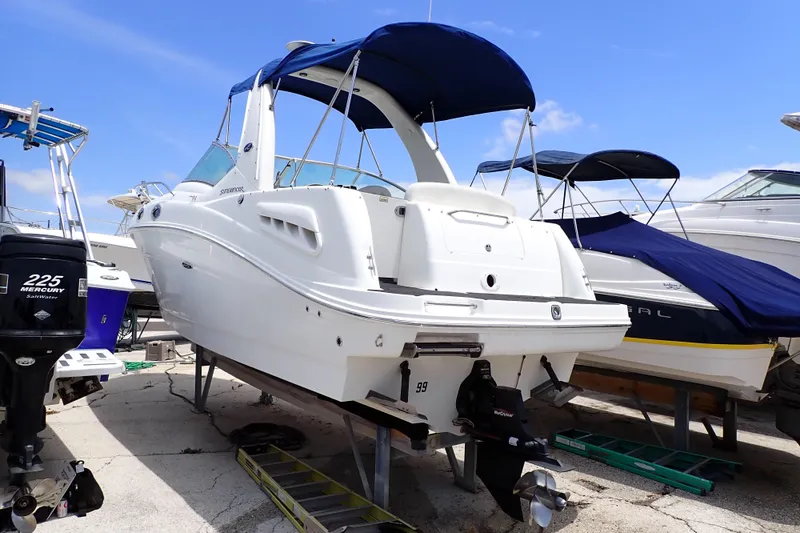 The Image of 2005 Sea Ray Sundancer 260 boat on dry dock with blue canopy. - 0