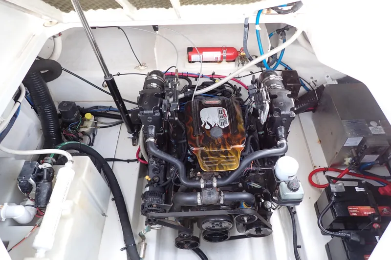 Slide: The Image of Engine compartment of a 2005 Sea Ray Sundancer 260 boat, featuring a well-maintained motor. - 100