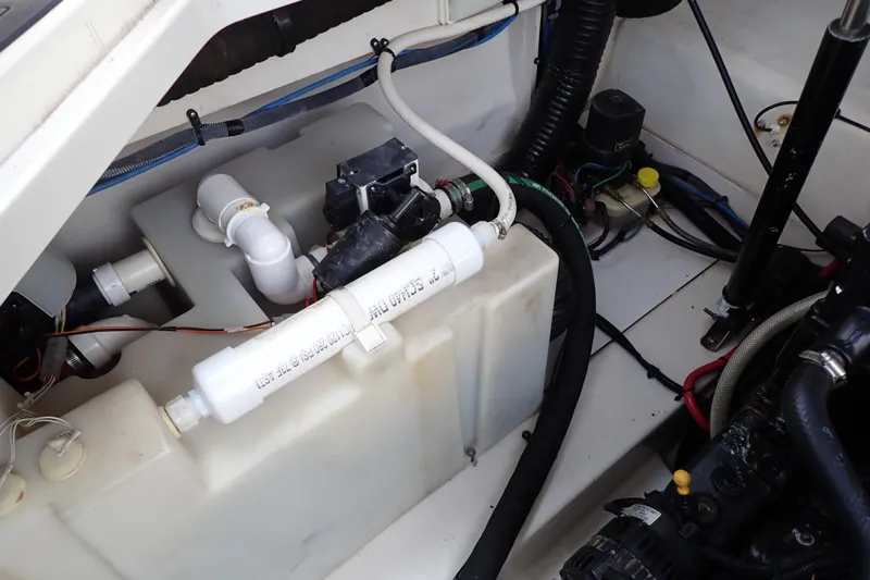 Slide: The Image of Engine compartment of a 2005 Sea Ray Sundancer 260 boat, showing mechanical components and wiring. - 102