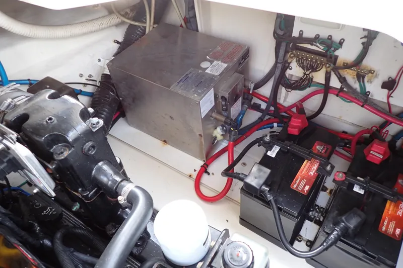 Slide: The Image of Engine compartment of 2005 Sea Ray Sundancer 260 with batteries and wiring. - 104