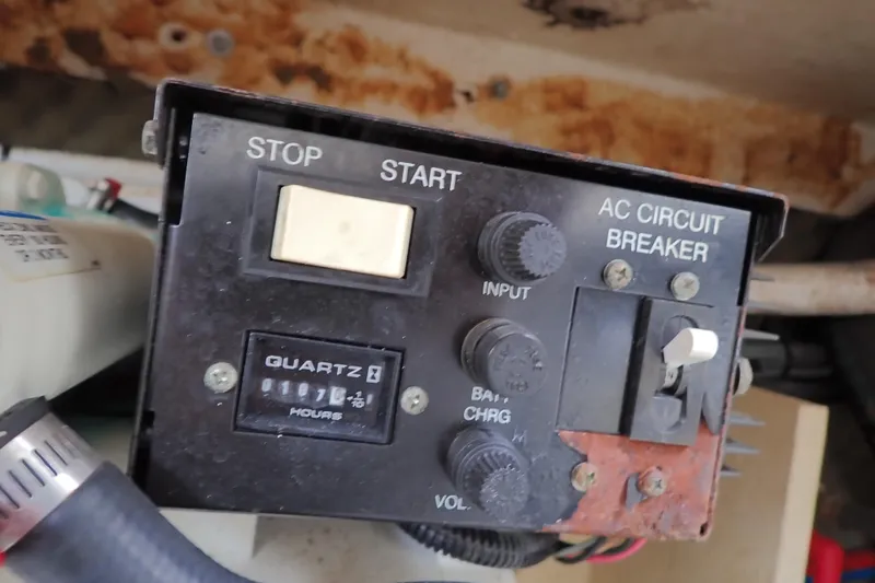 Slide: The Image of Control panel of a 2005 Sea Ray Sundancer 260 boat with AC circuit breaker. - 107