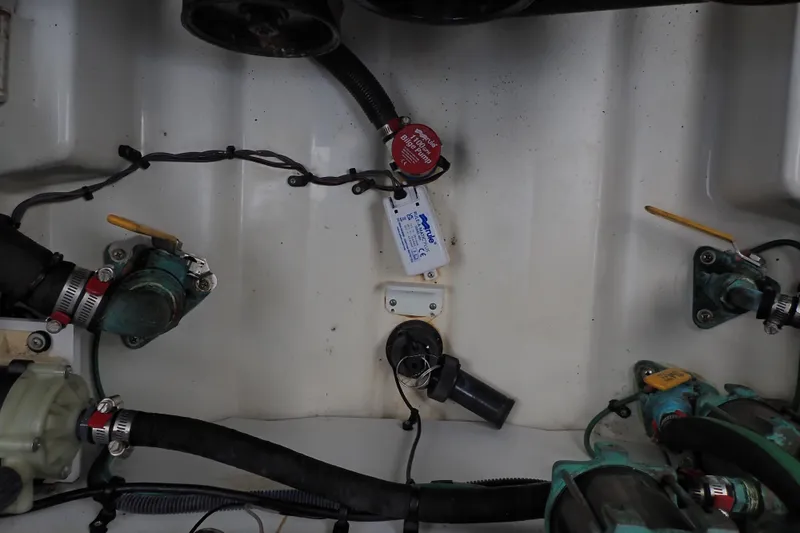 Slide: The Image of Engine compartment of a 2005 Sea Ray Sundancer 260, showing hoses and components. - 109