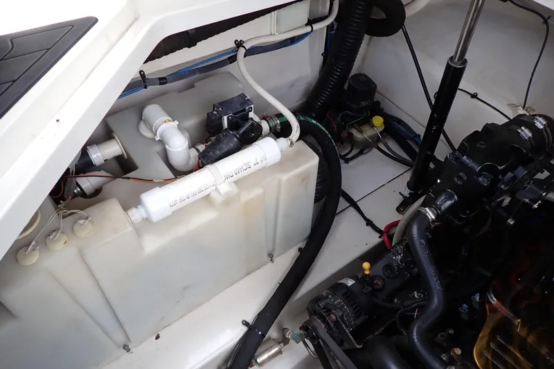 Slide: The Image of Engine compartment of a 2005 Sea Ray Sundancer 260 boat, showing mechanical components. - 112