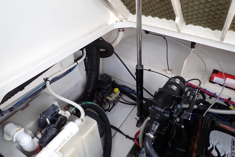 Slide: The Image of Engine compartment of a 2005 Sea Ray Sundancer 260, showcasing mechanical components and wiring. - 113