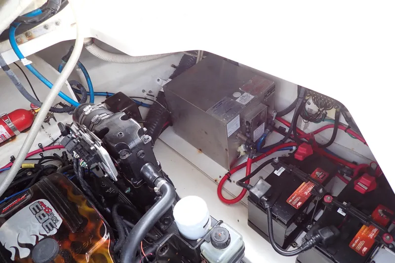 Slide: The Image of Engine compartment of a 2005 Sea Ray Sundancer 260 with visible wiring and components. - 114