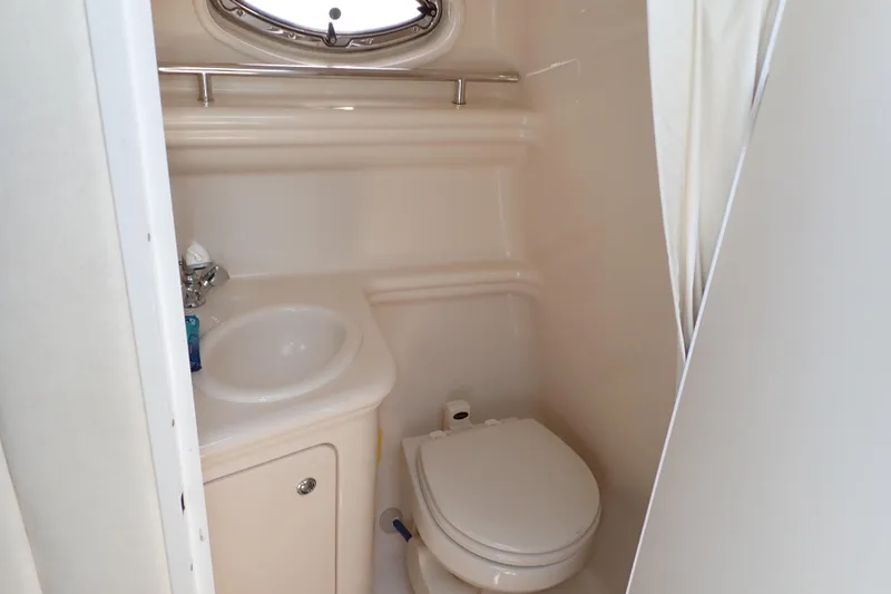 Slide: The Image of Compact bathroom in 2005 Sea Ray Sundancer 260 boat, featuring sink and toilet. - 12