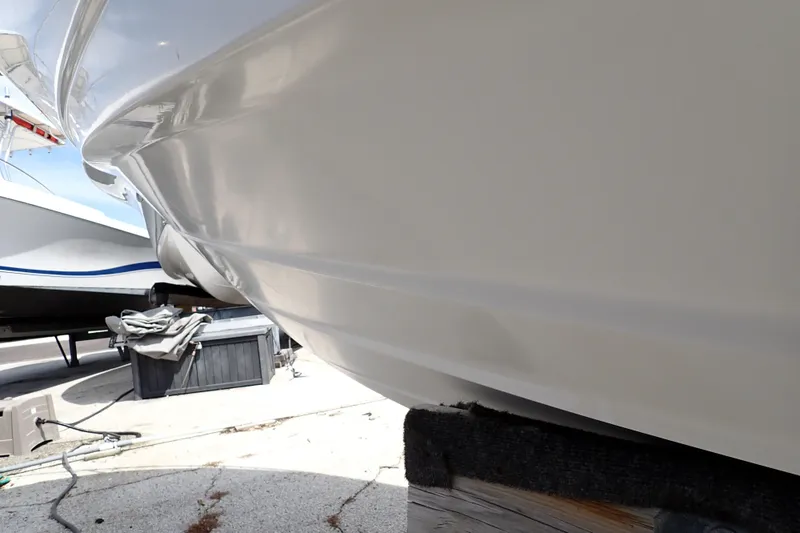 Slide: The Image of 2005 Sea Ray Sundancer 260 boat hull on dry dock, showcasing sleek design and smooth finish. - 127
