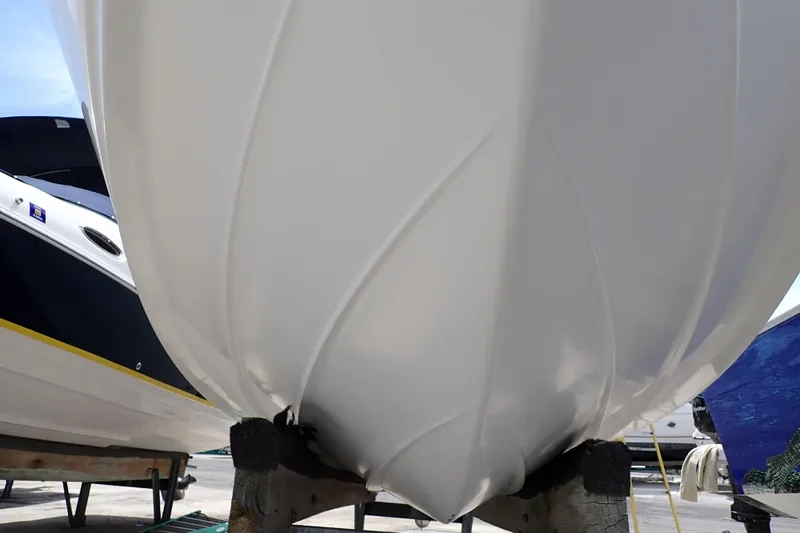 Slide: The Image of 2005 Sea Ray Sundancer 260 boat hull on dry dock, showcasing sleek design and craftsmanship. - 128