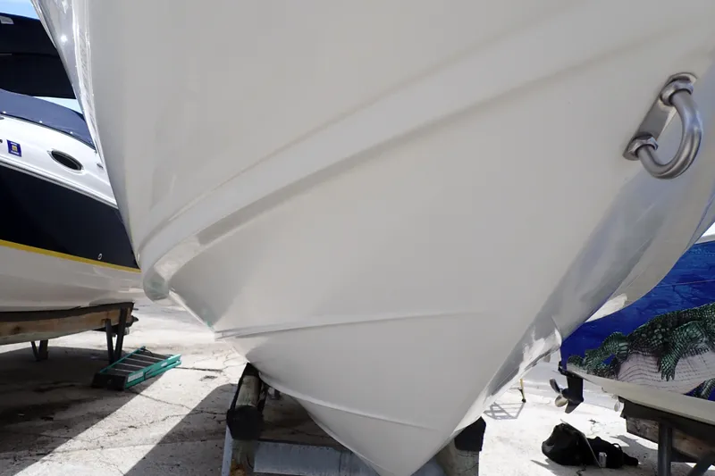 Slide: The Image of 2005 Sea Ray Sundancer 260 boat hull on dry dock, showcasing sleek design and craftsmanship. - 129