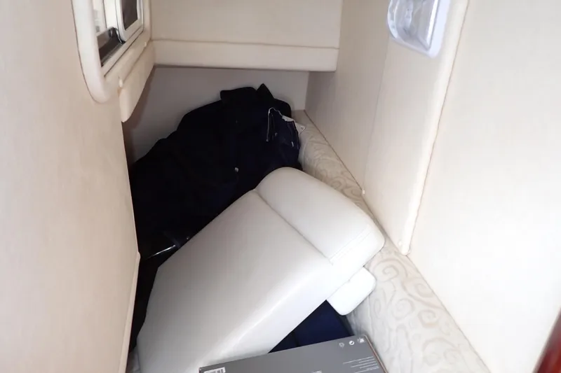 Slide: The Image of Interior cabin of 2005 Sea Ray Sundancer 260 with cushions and storage items. - 13