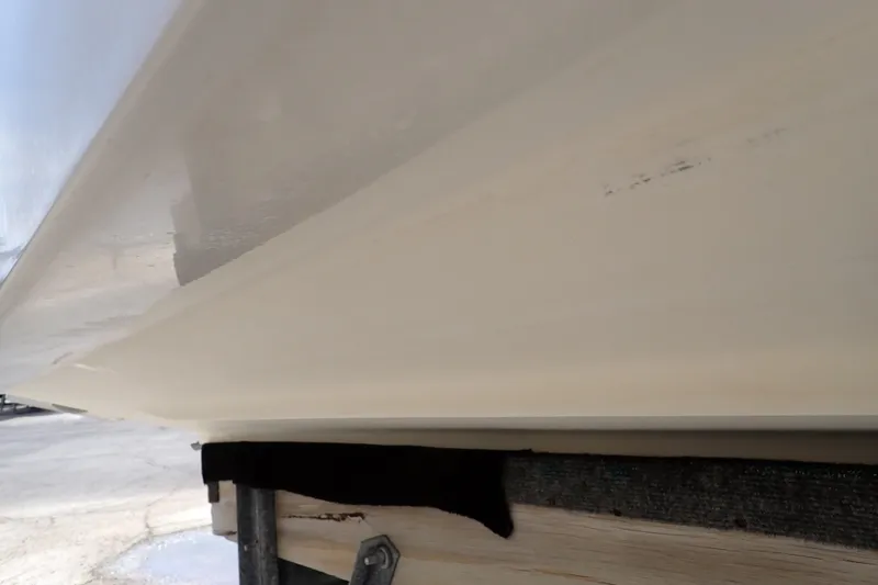 Slide: The Image of 2005 Sea Ray Sundancer 260 hull on trailer, showcasing smooth, clean surface. - 132