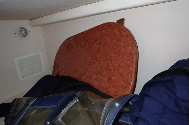 Slide: The Image of Interior of a 2005 Sea Ray Sundancer 260 with wooden table and storage items. - 15