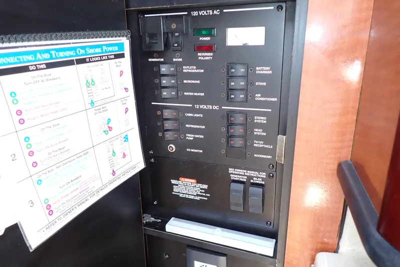 Slide: The Image of Electrical control panel on a 2005 Sea Ray Sundancer 260 boat, featuring AC and DC switches. - 16
