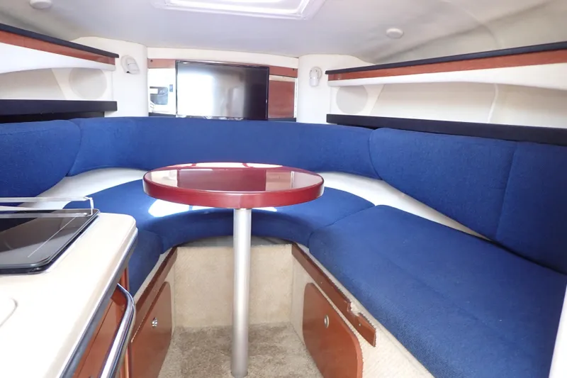 Slide: The Image of Interior of 2005 Sea Ray Sundancer 260 with blue seating and round table. - 18