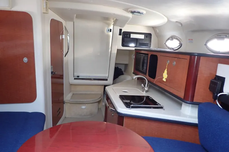 Slide: The Image of Interior of 2005 Sea Ray Sundancer 260 boat with kitchenette and seating area. - 20