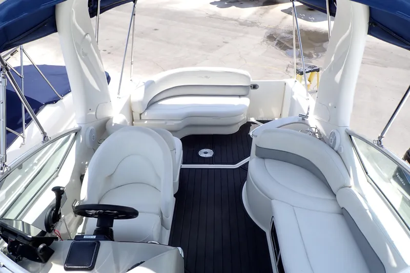 Slide: The Image of 2005 Sea Ray Sundancer 260 boat interior with white seating and black flooring. - 27