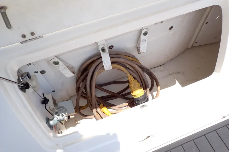 Slide: The Image of Storage compartment on 2005 Sea Ray Sundancer 260 with coiled power cable. - 29
