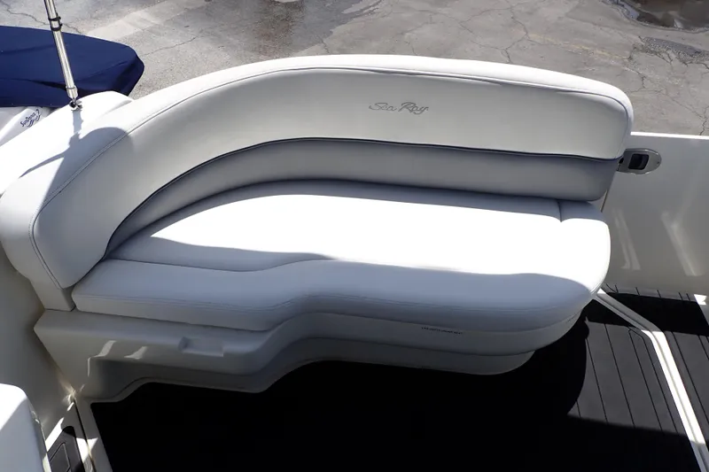 Slide: The Image of 2005 Sea Ray Sundancer 260 boat seating with white upholstery and sleek design. - 32