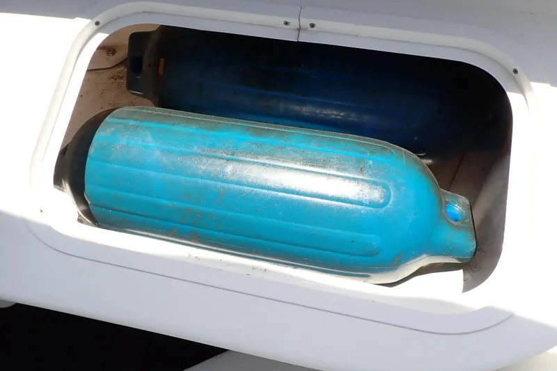 Slide: The Image of Storage compartment with blue fenders on a 2005 Sea Ray Sundancer 260 boat. - 33