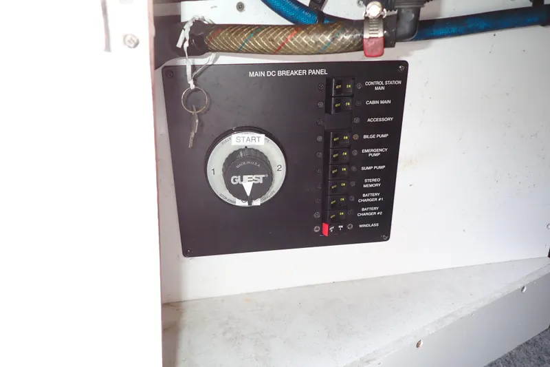 Slide: The Image of Main DC breaker panel on 2005 Sea Ray Sundancer 260 boat, featuring control switches and key start. - 37