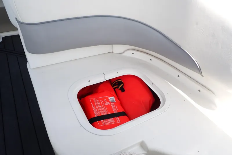 Slide: The Image of Storage compartment with life jacket on 2005 Sea Ray Sundancer 260 boat. - 39