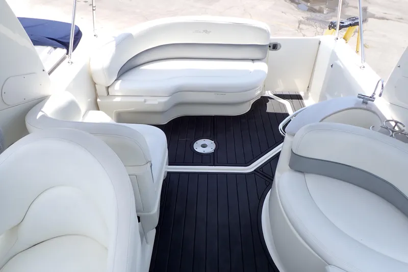 Slide: The Image of 2005 Sea Ray Sundancer 260 interior with white seating and dark flooring. - 4