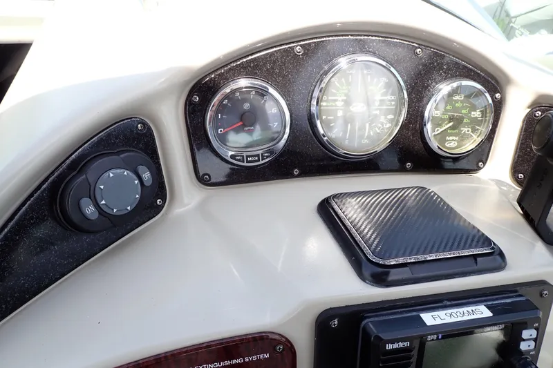 Slide: The Image of Dashboard of a 2005 Sea Ray Sundancer 260 boat with gauges and controls. - 43