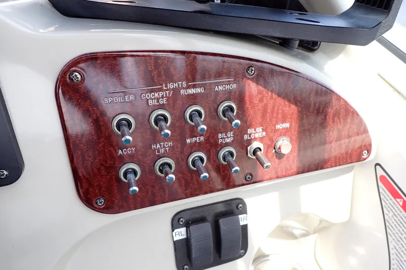 Slide: The Image of Control panel of a 2005 Sea Ray Sundancer 260 boat with various switches. - 45