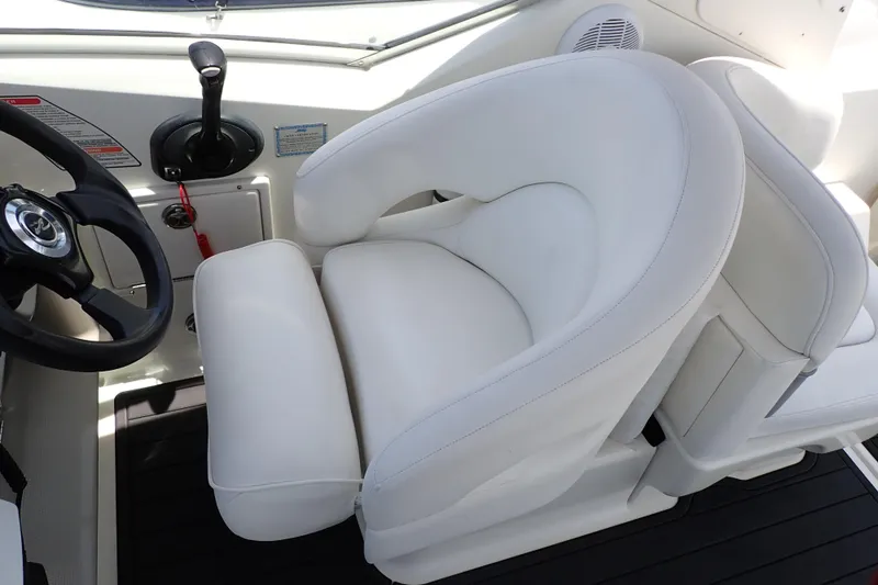 Slide: The Image of Captain's seat and steering wheel of 2005 Sea Ray Sundancer 260 boat. - 48