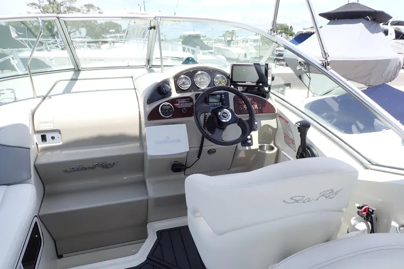 Slide: The Image of 2005 Sea Ray Sundancer 260 helm with steering wheel, gauges, and navigation equipment. - 5