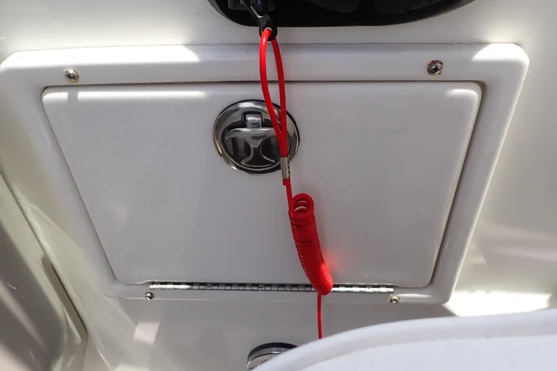 Slide: The Image of Storage compartment on a 2005 Sea Ray Sundancer 260 boat with red safety cord. - 51