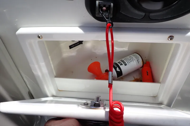 Slide: The Image of Storage compartment on a 2005 Sea Ray Sundancer 260 with safety equipment. - 52