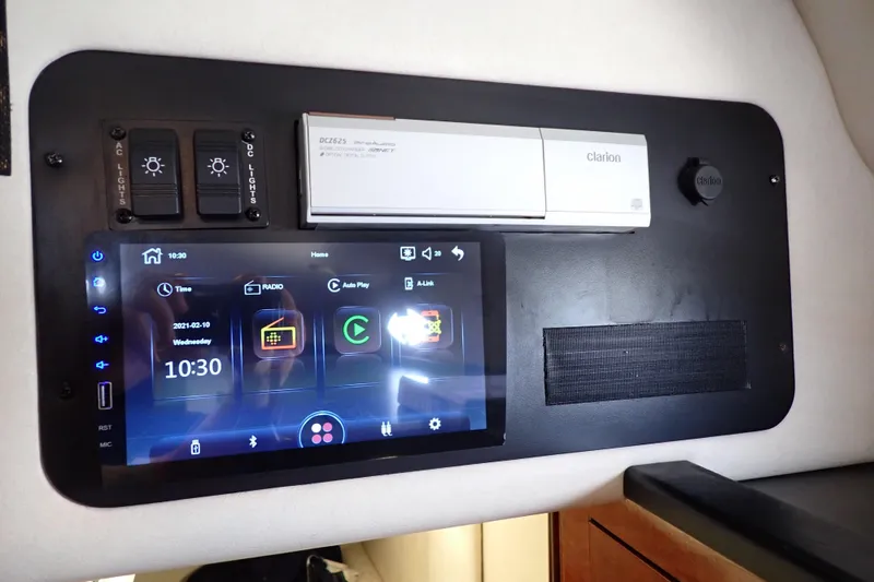 Slide: The Image of Control panel of a 2005 Sea Ray Sundancer 260 with touchscreen and Clarion audio system. - 54