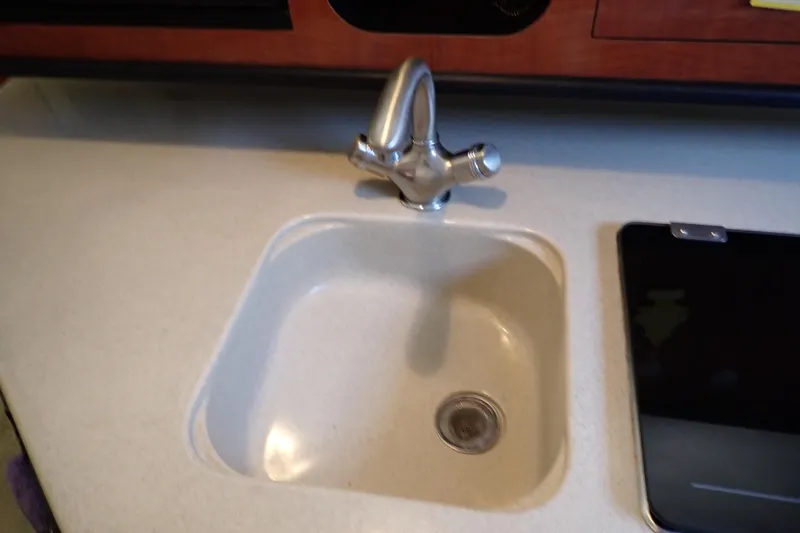 Slide: The Image of Sink and faucet in 2005 Sea Ray Sundancer 260 boat kitchen area. - 56